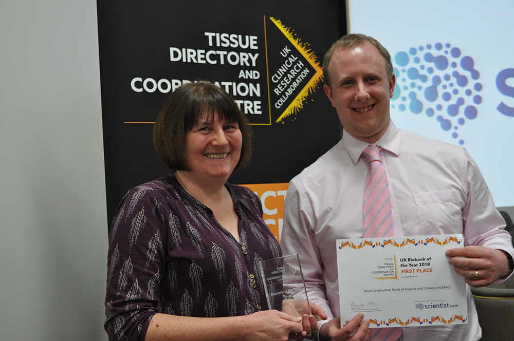 Sue Ring and Phil Quinlan posing with award and certificate